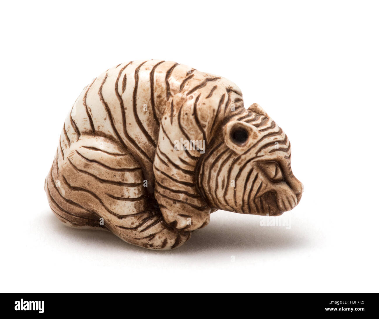Small Japanese accessory of a seated tiger. A miniature sculpture