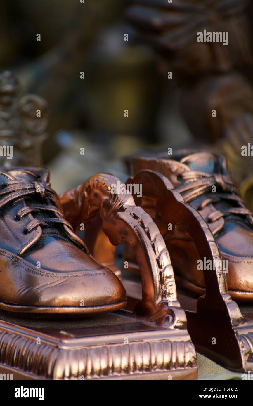 Close-Up of Antique Bronzed Metal Baby Shoes with Laces as Bookends at Hell's Kitchen Flea Market Manhattan NYC New York Stock Photo