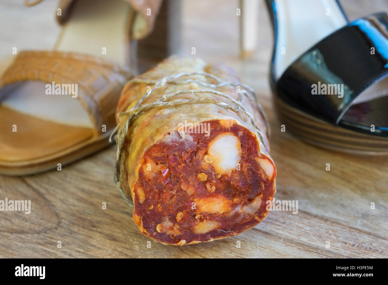 soppressata salami photographed near women shoes Stock Photo Alamy