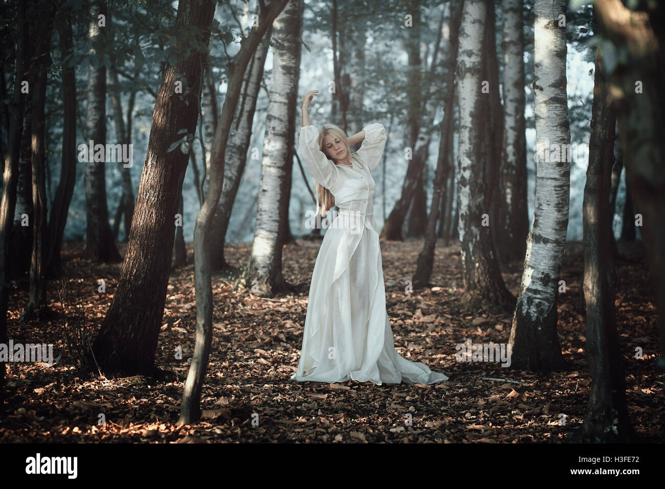 Beautiful woman dancing in ethereal forest . Fantasy and surreal Stock Photo
