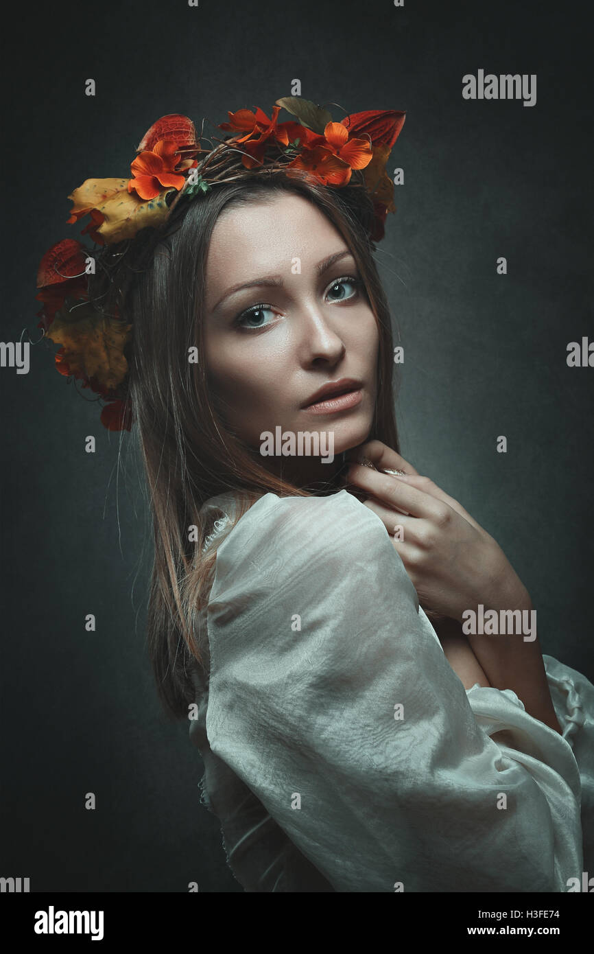 Woman with autumn leaves crown . Studio portrait Stock Photo