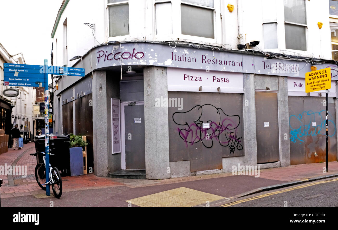 Piccolo Italian restaurant closed down and boarded up in The Lanes area of Brighton UK Stock Photo