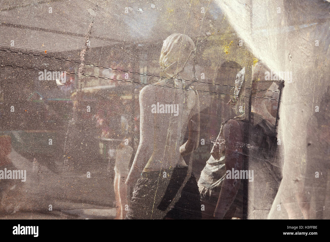 Manikins used as a target for paint ball, view through the safety netting behind. Stock Photo