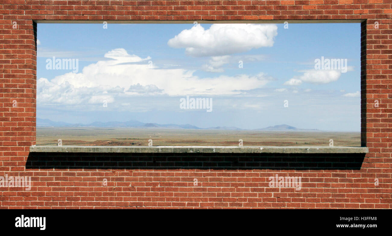 Opening frame in a brick wall provides ever changing scenery Stock Photo