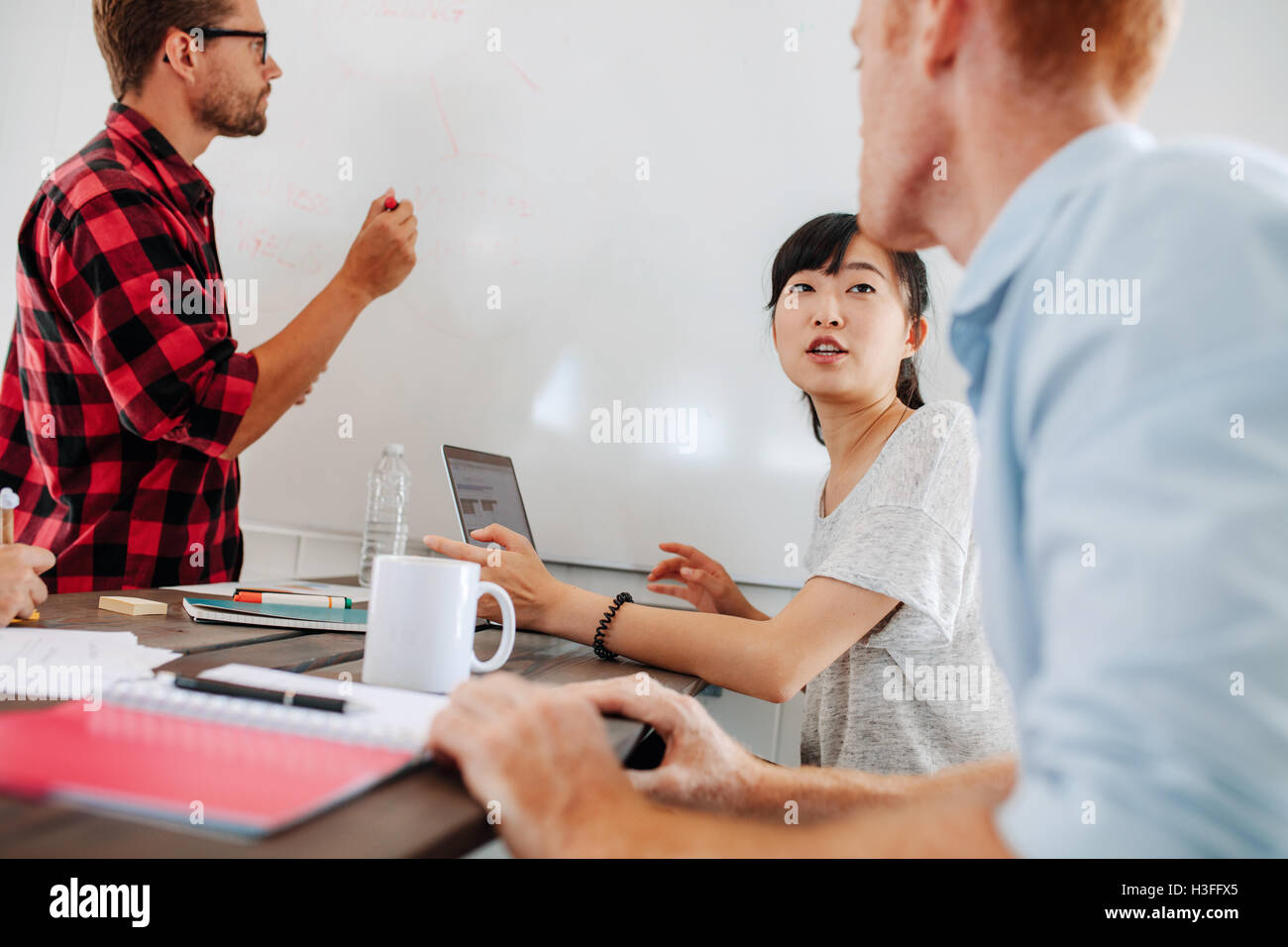 Business people sitting at conference table and discussing during ...