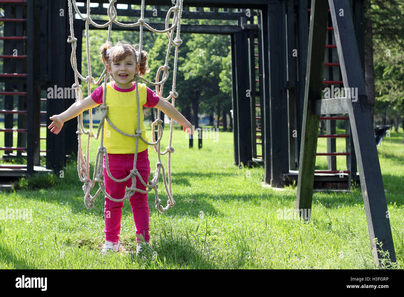 happy little girl on park playground Stock Photo - Alamy