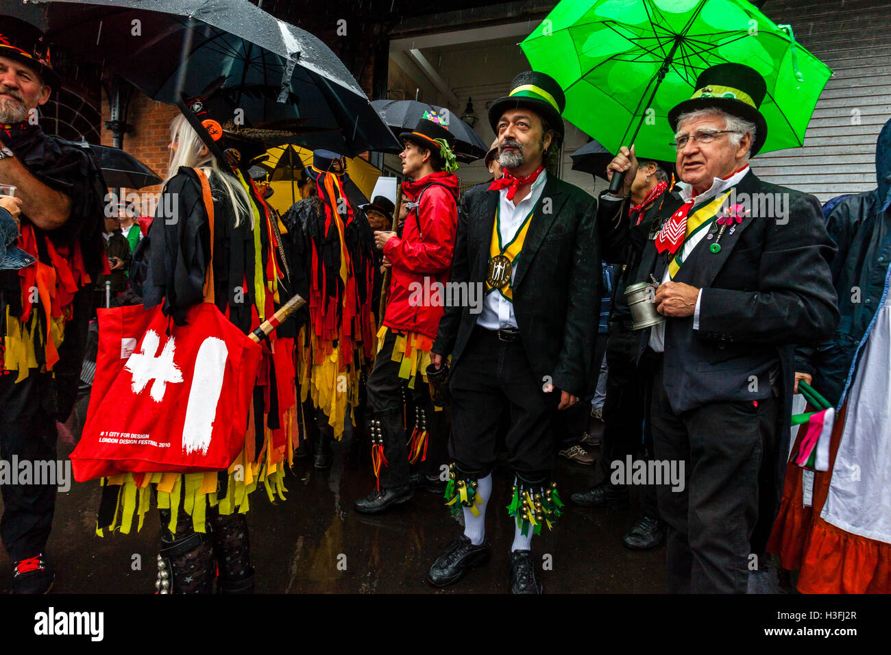 Morris Dancers Stand In The Rain Waiting To Perform In The 'Dancing In The Old' Event Held At Harvey's Brewery, Lewes, UK Stock Photo