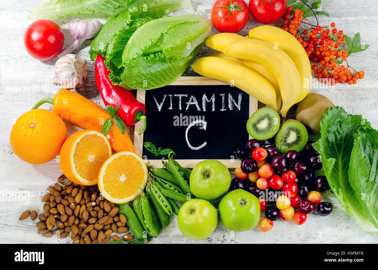 Foods High in vitamin C on white wooden board.  Healthy eating. Flat lay Stock Photo