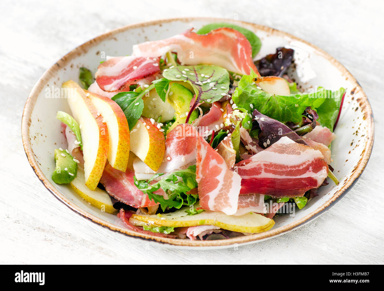 Fresh mix salad with bacon and pear. Selective focus Stock Photo