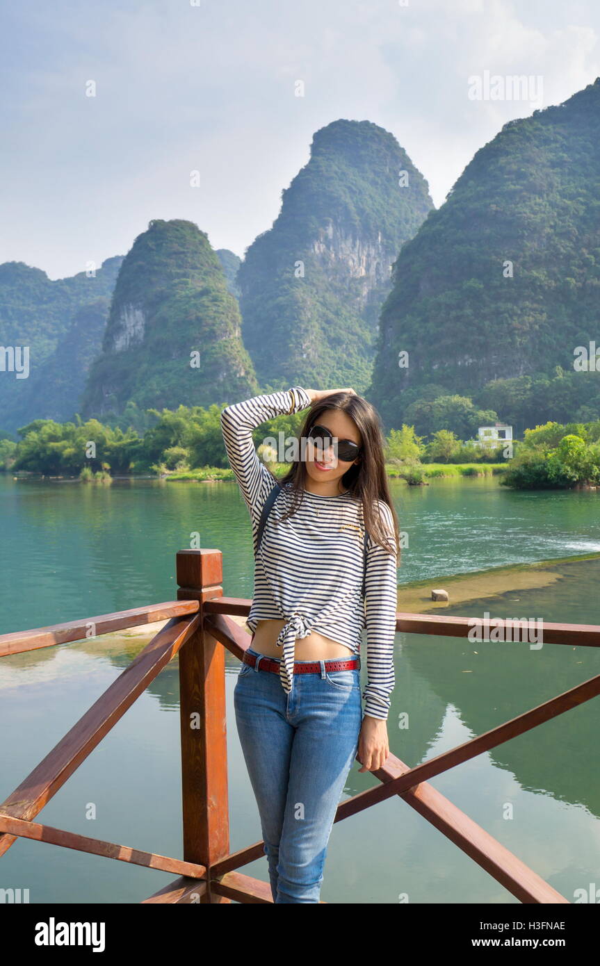 Beautiful girl at hiking trip in karst rocks area of Guilin Stock Photo