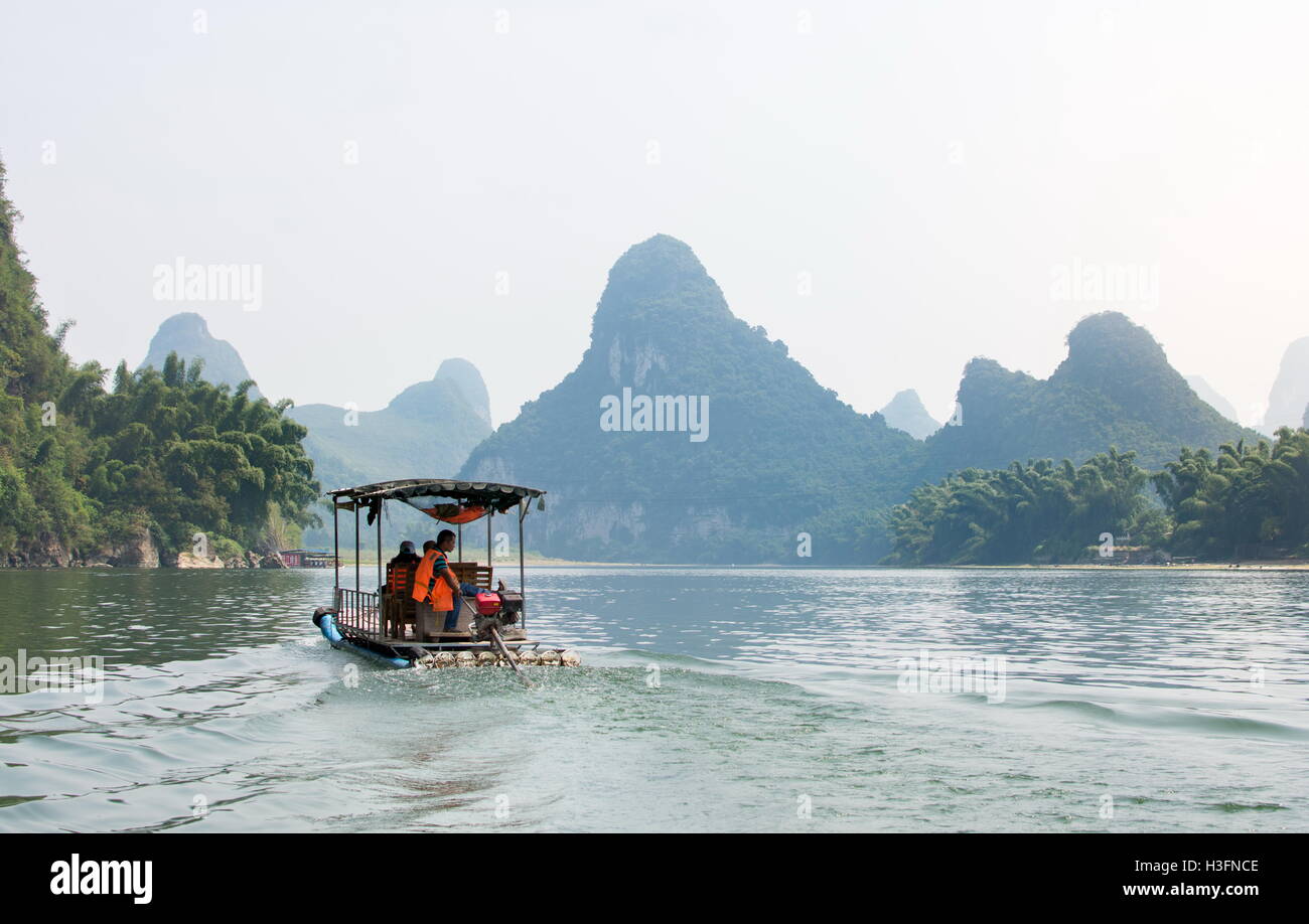 YANGSHOU, CHINA - SEPTEMBER 23, 2016: Tourists on a Li River Cruise, with a view at karst rocks scenery Stock Photo