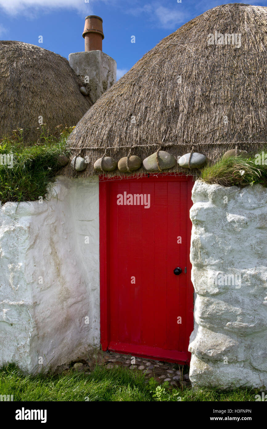 Typical old Cottage with Stones on Thatch,Balevullin Bay,Tiree,Inner Hebrides,Argyll and Bute,Scotland Stock Photo