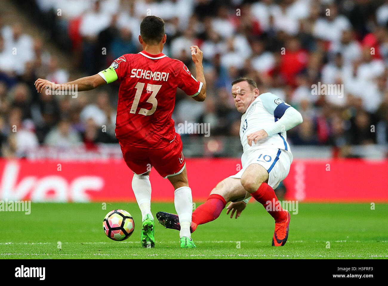 England's Wayne Rooney (right) challenges Malta's Andre Schembri during the 2018 FIFA World Cup Qualifying match at Wembley Stadium, London. Stock Photo