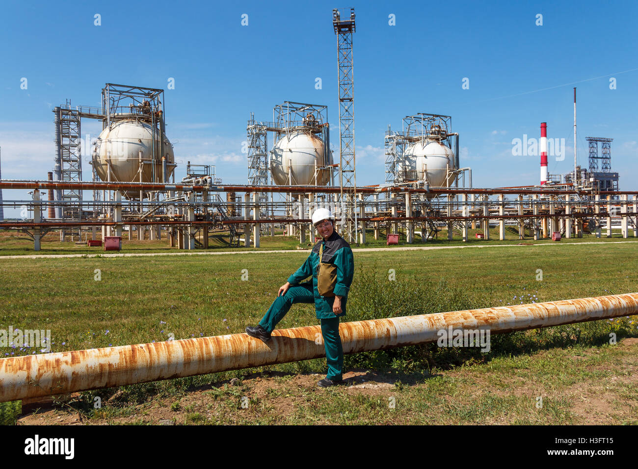 Smiling refinery woman worker on petrochemical factory Stock Photo