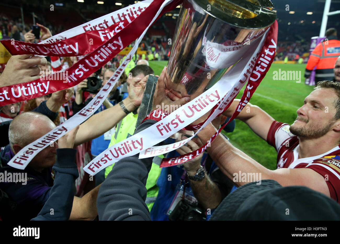 Wigan Warriors fans handle the trophy as its passed around the crowd ...