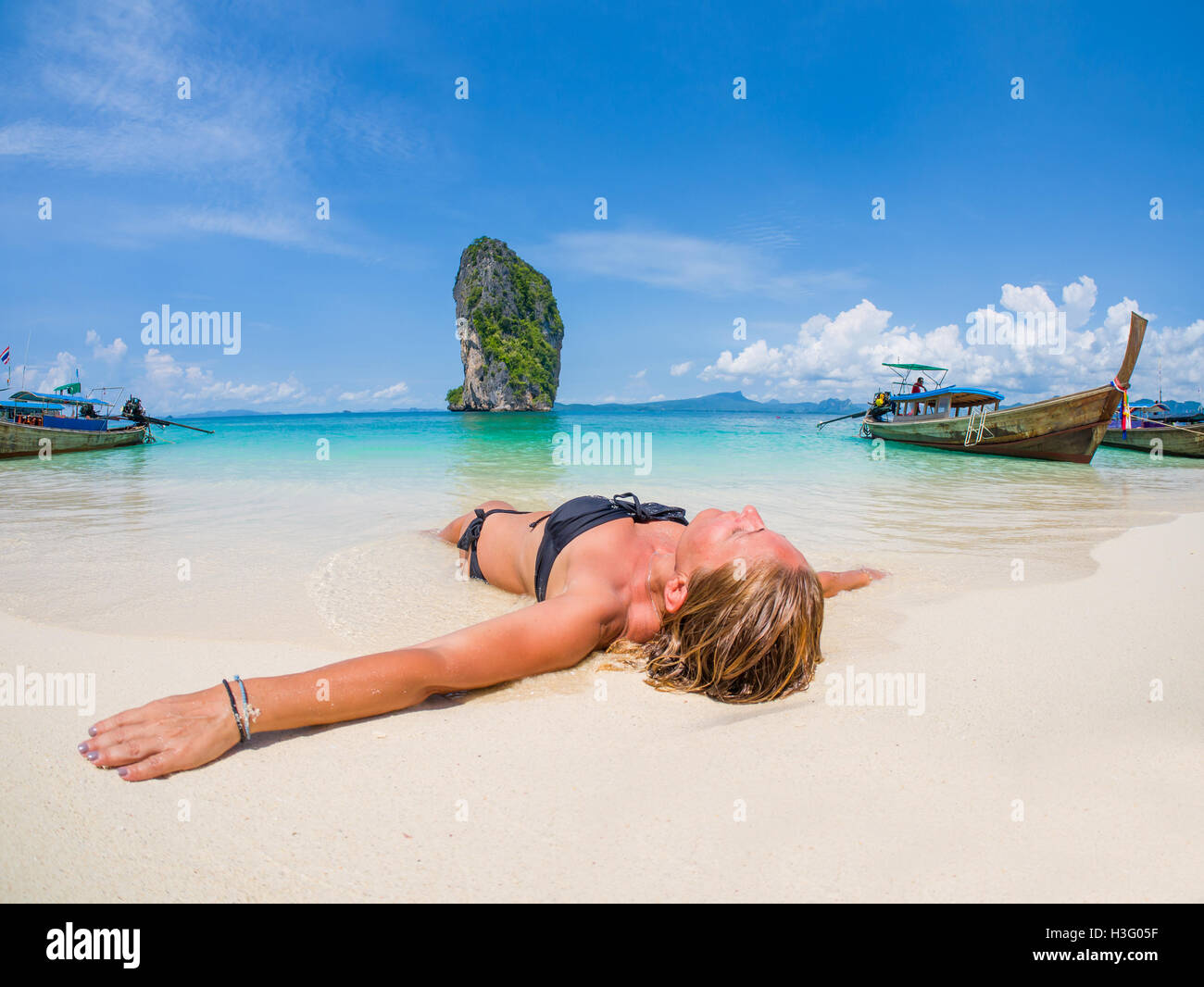Beautiful woman on the beach in thailand winter holidays in the sun