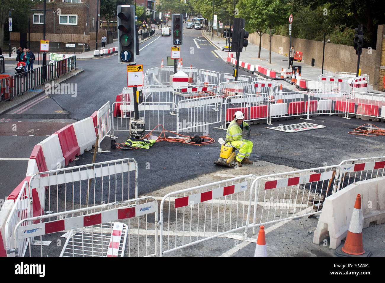 roadworks worker sitting down doing nothing rest Stock Photo