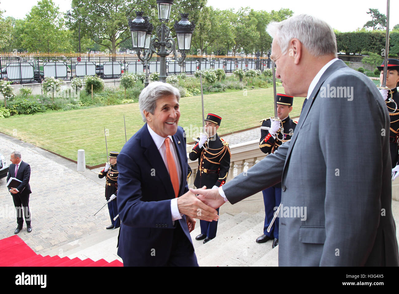 U.S. Secretary of State John Kerry shakes hands with French Foreign Minister Jean-Marc Ayrault upon arrival at the French Ministry of Foreign Affairs in Paris, France on July 30, 2016. Stock Photo