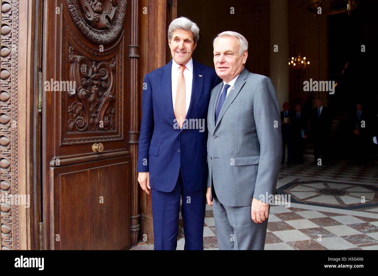 U.S. Secretary of State John Kerry poses for a photo with French Foreign Minister Jean-Marc Ayrault upon arrival at the French Ministry of Foreign Affairs in Paris, France on July 30, 2016. Stock Photo