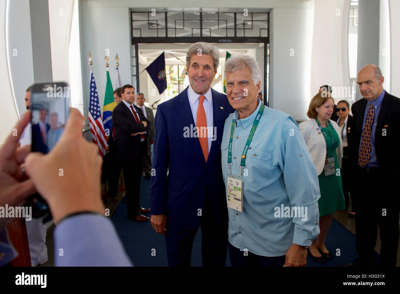 U.S. Secretary of State John Kerry poses for a cellphone photo with Mark Spitz - Olympic gold medalist and fellow U.S. Presidential Delegation member - as they visit the Brazilian Naval Academy in Rio de Janiero, Brazil, on August 5, 2016, before they meet members of Team USA training at the facility. Stock Photo