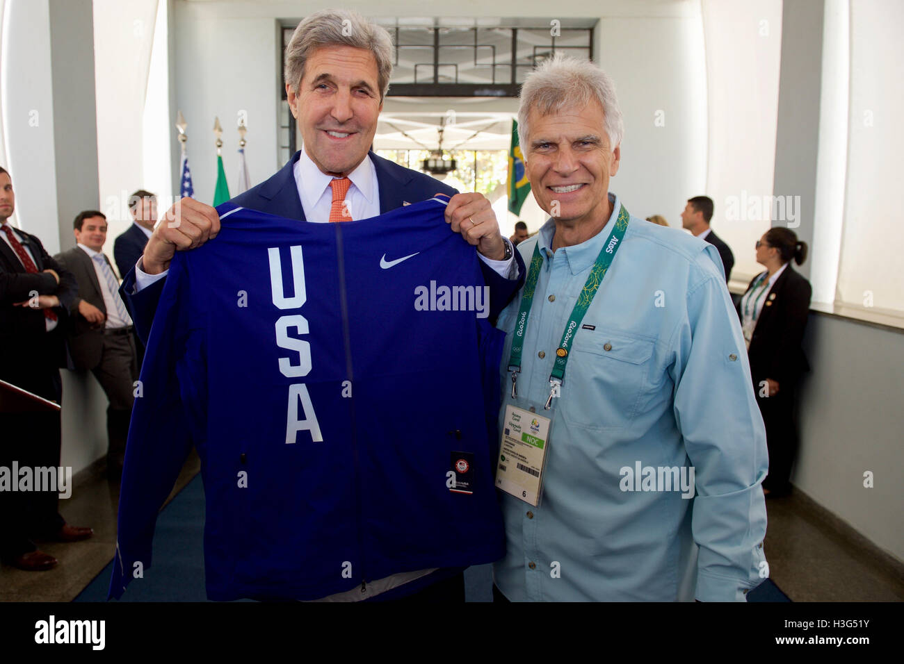 U.S. Secretary of State John Kerry and Mark Spitz - Olympic gold medalist and fellow U.S. Presidential Delegation member - pose with a Team USA jersey as they visit the Brazilian Naval Academy in Rio de Janiero, Brazil, on August 5, 2016, before they meet U.S. athletes training at the facility. Stock Photo