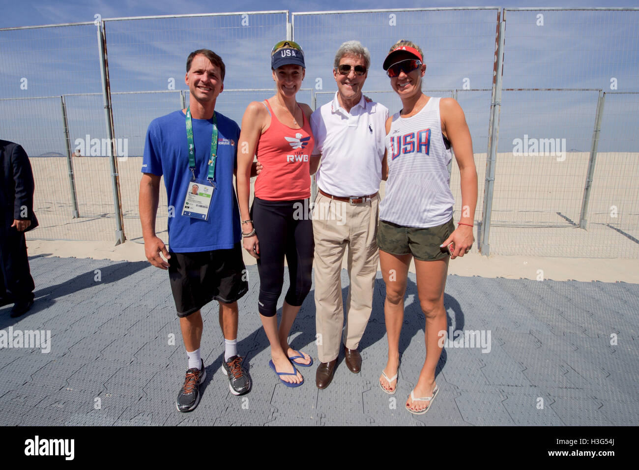 U.S. Secretary of State John Kerry poses for a photo with U.S. Olympic women's beach volleyball players Kerri Walsh and April Ross, and their coach Marcio Sicoli, on the Copacobana beach in Rio de Janiero, Brazil, on August 6, 2016, as he and his fellow members of the U.S. Presidential Delegation attend the Summer Olympics. Stock Photo