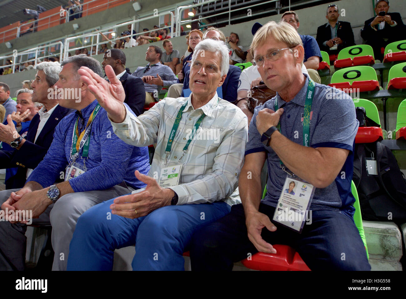 Olympic gold medal swimmer Mark Spitz speaks with Olympic gymnast Bart Conner during a preliminary round of men's gymnastics at Olympic Park in Rio de Janiero, Brazil, on August 6, 2016, as U.S. Secretary of State John Kerry and his fellow members of the U.S. Presidential Delegation attend the Summer Olympics. Stock Photo