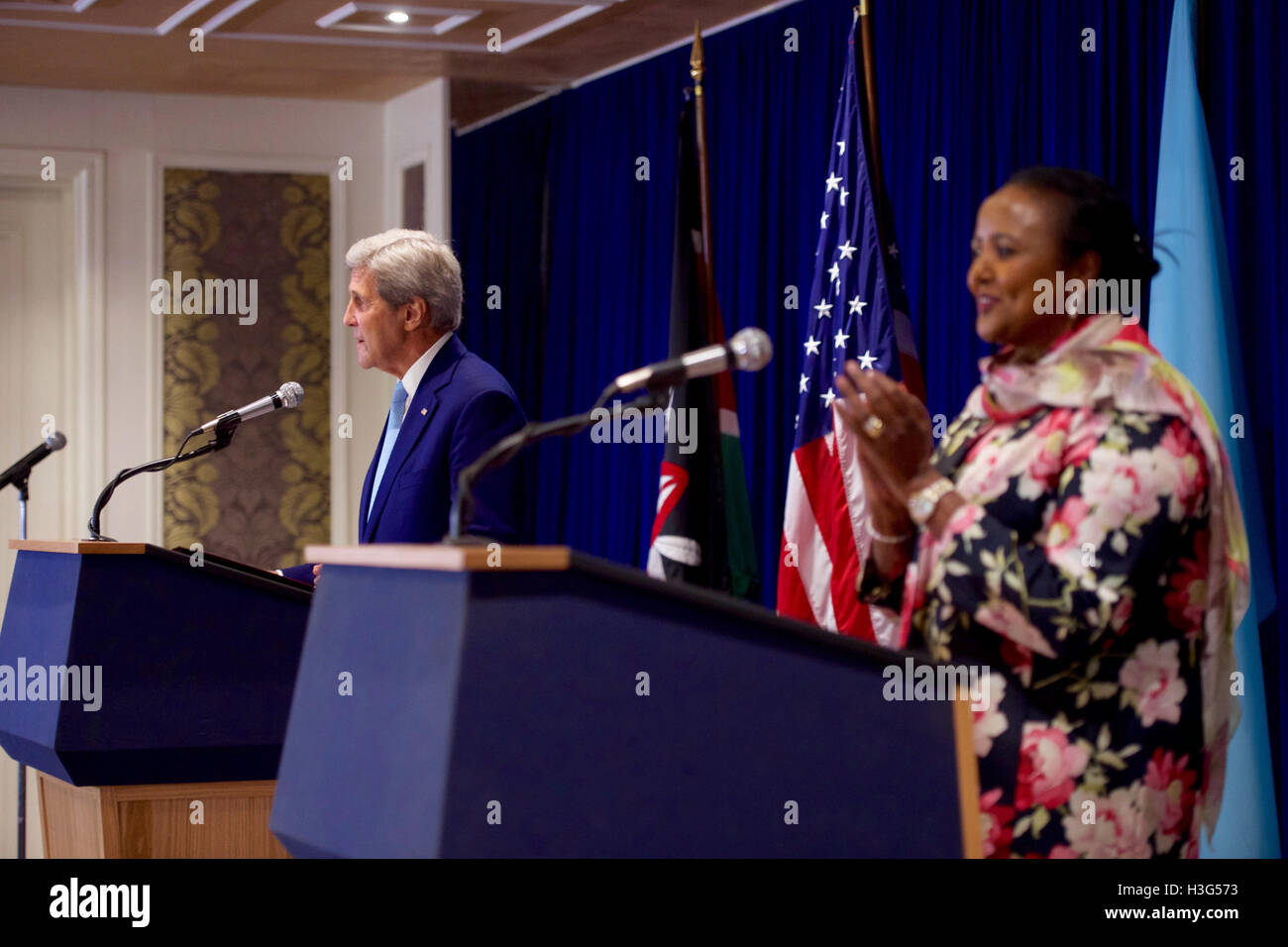 Kenyan Foreign Secretary Amina Mohamed applauds as U.S. Secretary of State John Kerry salutes the Kenyan Olympic Marathon winners during a joint news conference following a series of meetings on August 22, 2016, at the Villa Rosa Kempinski Hotel in Nairobi, Kenya. Stock Photo
