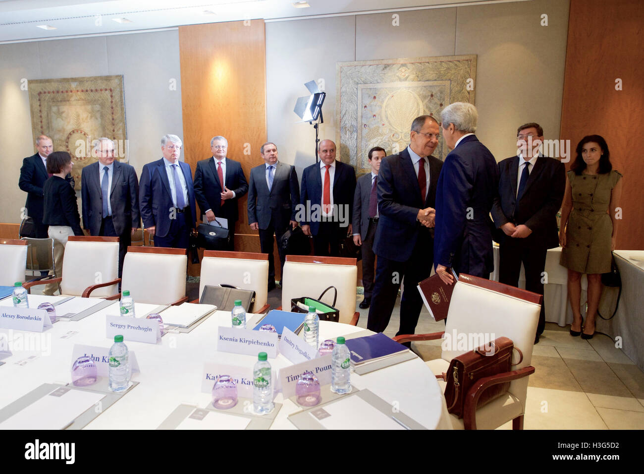 U.S. Secretary of State John Kerry shakes hands with Russian Foreign Minister Sergey Lavrov -- as his team looks on -- prior to a bilateral meeting on August 26, 2016, at the President Wilson Hotel in Geneva, Switzerland. [State Department photo/ ] Stock Photo