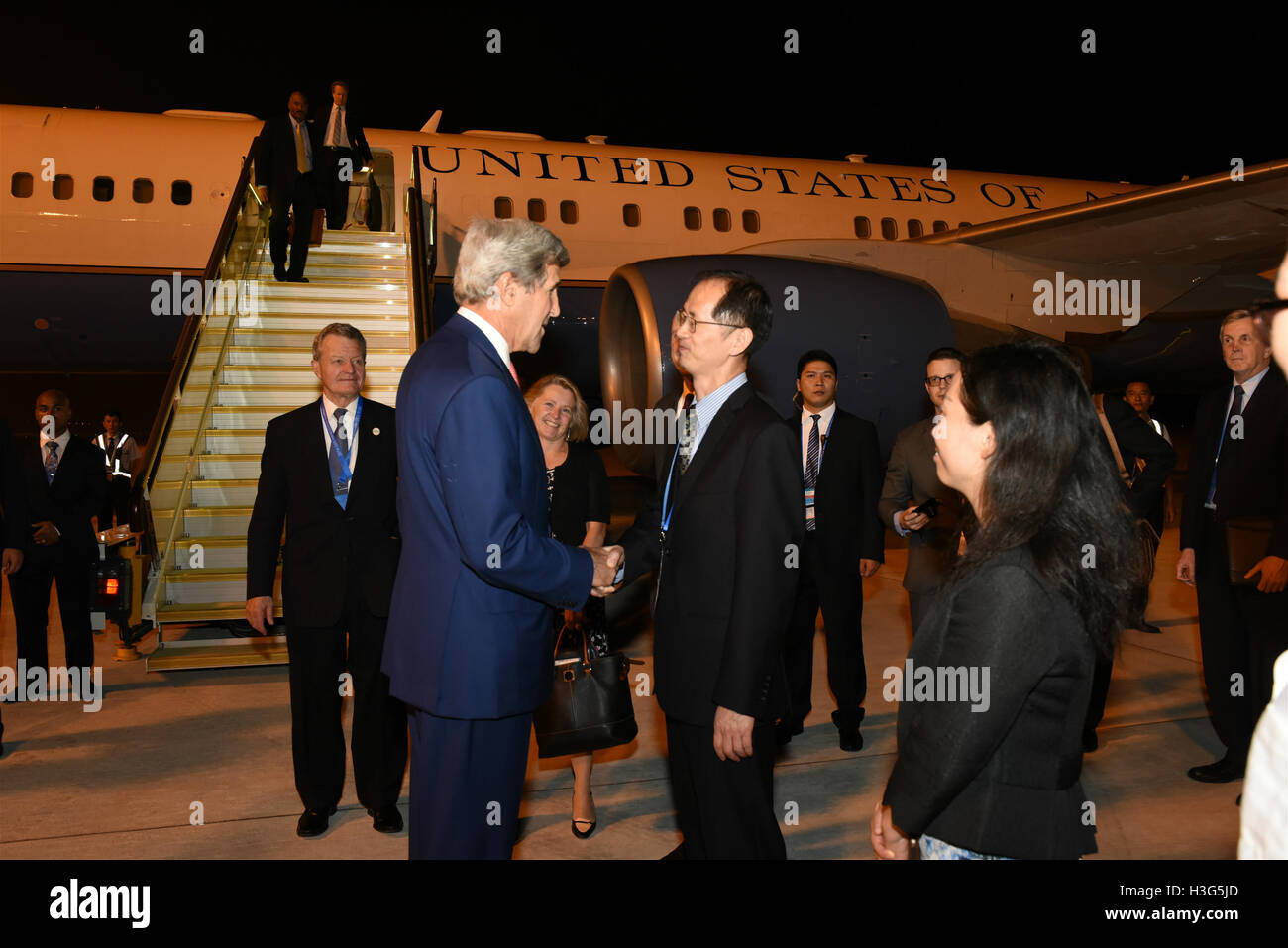 U.S. Secretary of State John Kerry shakes hands with Shi Yuanqiang, Counselor of Chinese Ministry of Foreign Affairs after arriving in Hangzhou, China on September 3, 2016. Secretary Kerry will follow President Obama's schedule and events surrounding the G20 Summit. Stock Photo