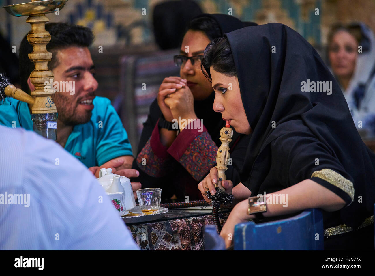 Iran, Kerman province, Kerman, Vakil hammam teahouse, iranian woman smoking a water pipe Stock Photo