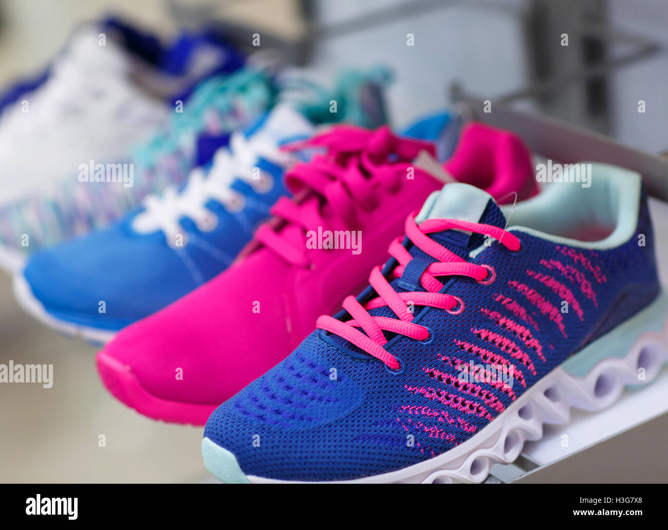 Variety of the colorful sneakers in the shop Stock Photo - Alamy