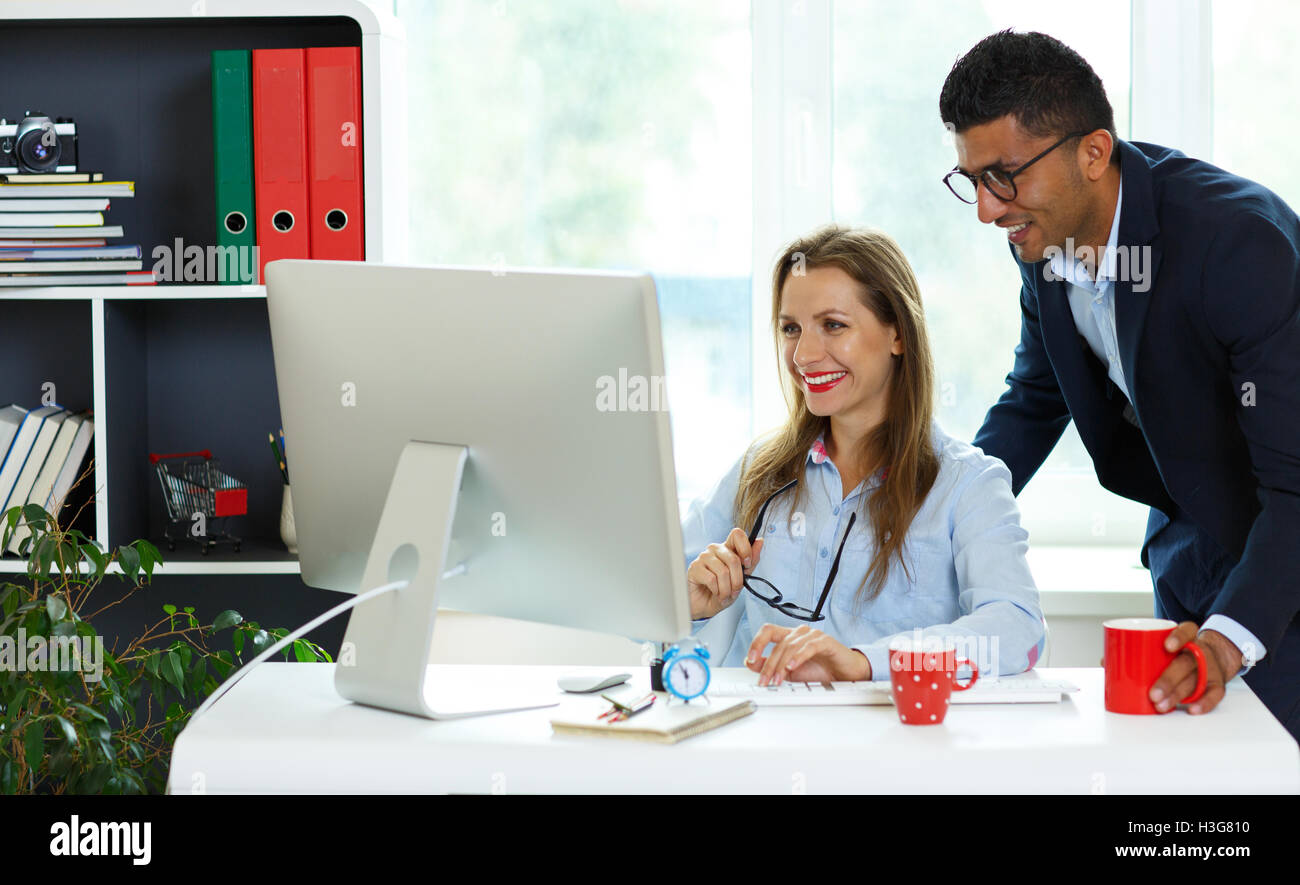 Beautiful young woman and man working from home - modern business ...