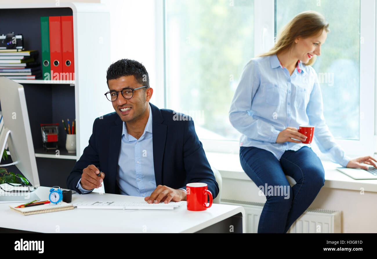 Beautiful young woman and man working from home - modern business ...