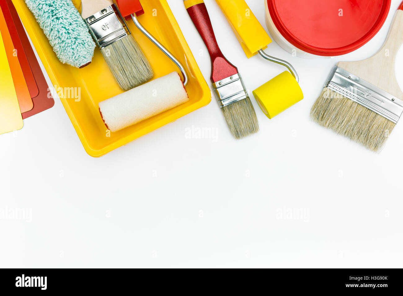 paint roller, tray, brushes, and paint can with color swatch Stock