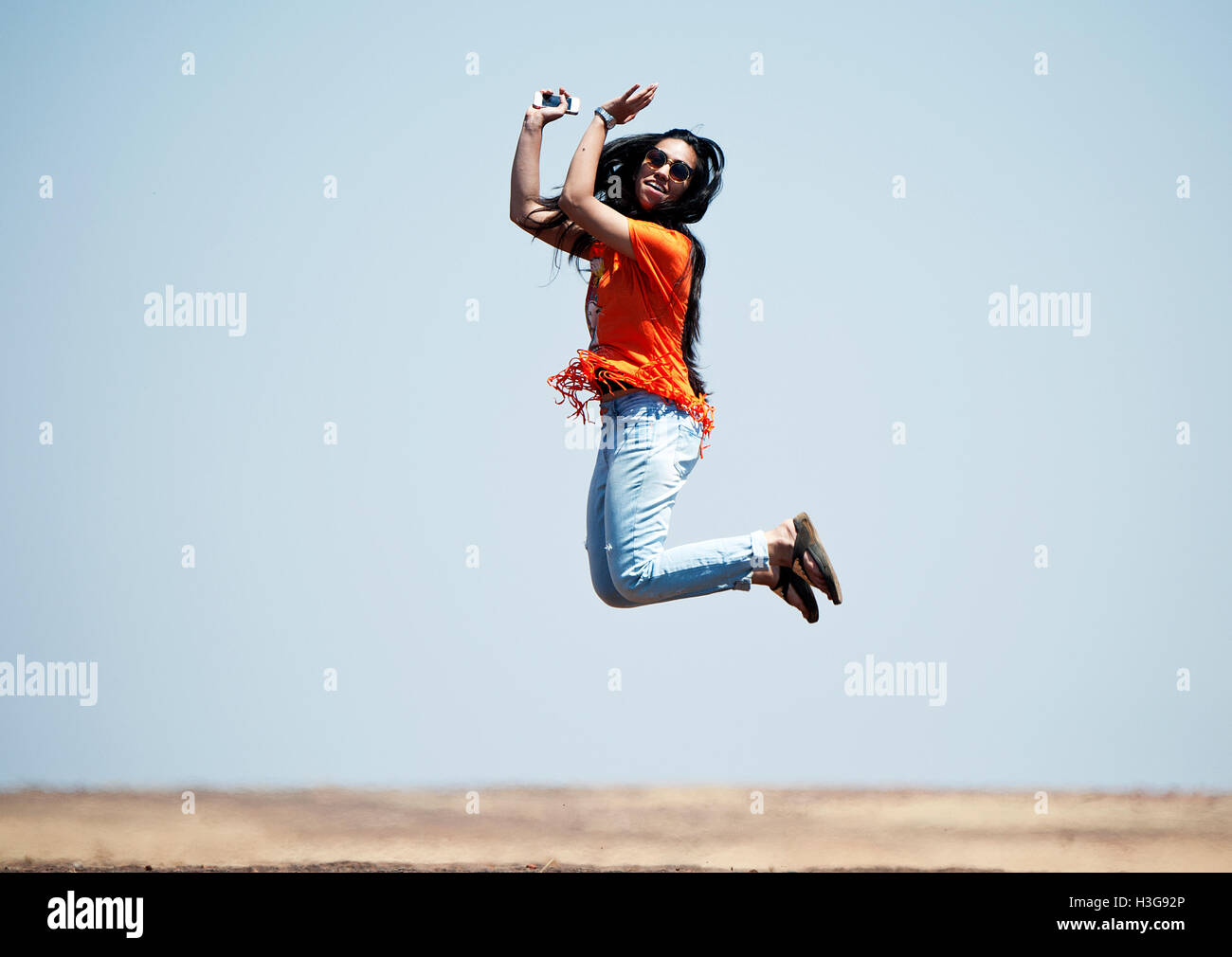 The image of Indian  teenage girl  jumping up in the air, India Stock Photo