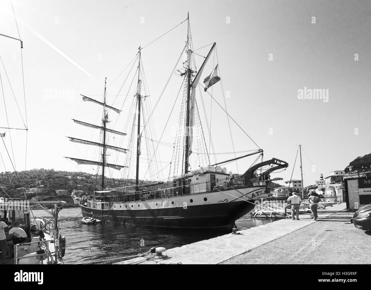 Three masted brig Atlantis of Amsterdam gets ready for departure with crew in port on a sunny day in Puerto Soller, Mallorca. Stock Photo