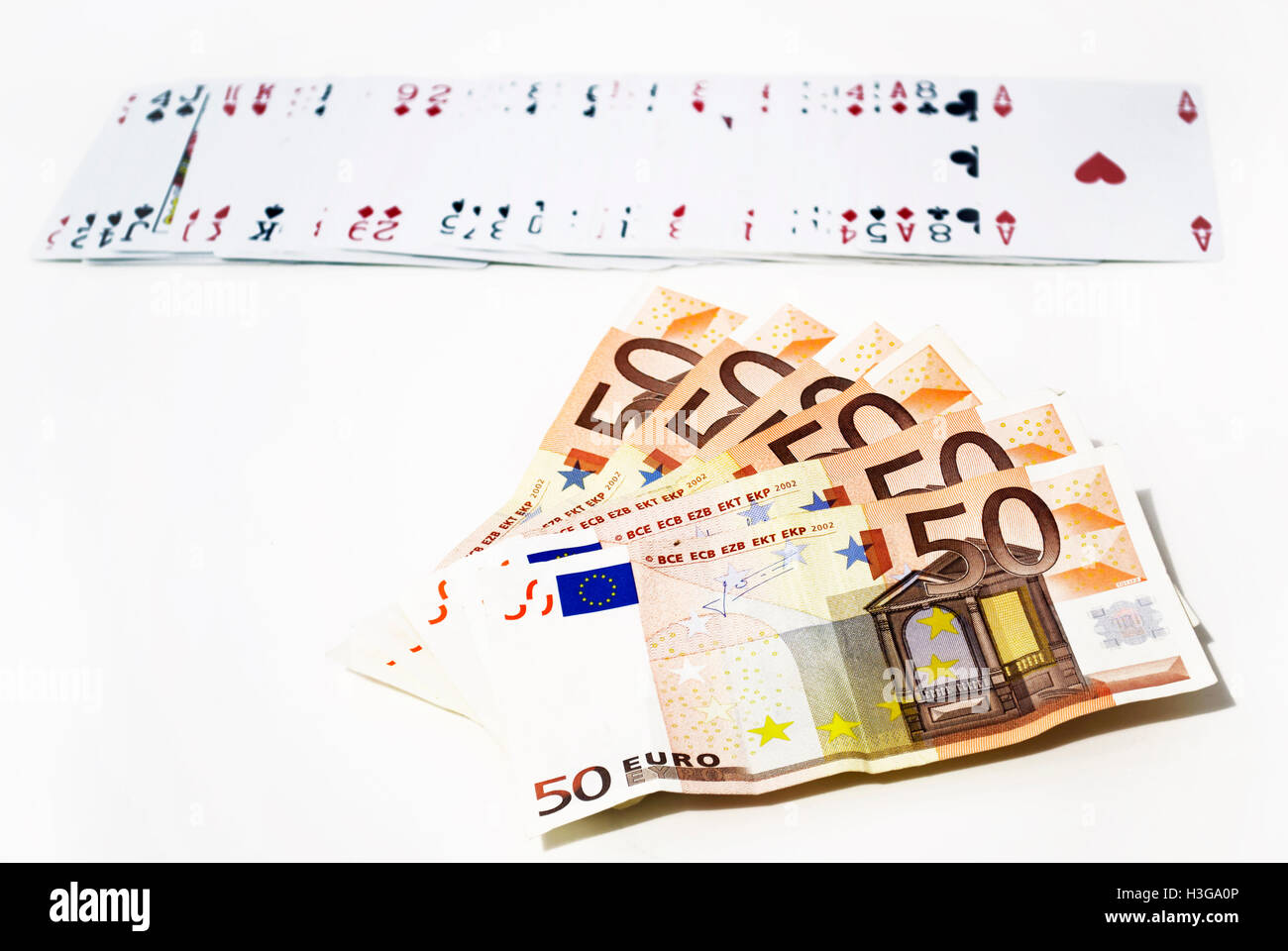 fifty euros and playing cards - gambling winnings concept Stock Photo