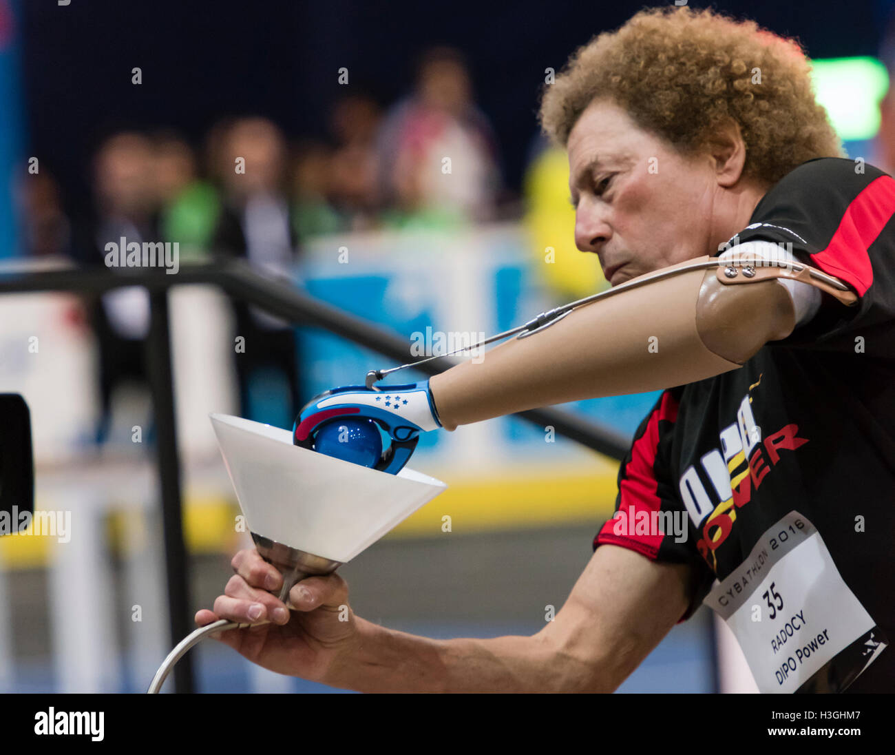 Kloten, Switzerland. 8th Oct, 2016. Bob Radocy (USA) is changing a lightbulb at the powered arm prosthetics race at Cybathlon, the first championship for racing pilots with disabilities using bionic devices at the Swiss Arena in Kloten (Zurich), Switzerland. Organized by the Swiss Federal Institute of Technology (ETH) in Zurich, Cybathlon brings together interdisciplinary teams of bio-engineers, scientists and athletes with physical disabilities to compete in solving everyday tasks and to demonstrate how technology enables them to overcome physical limitations of their body. © Erik Tham/Alamy Stock Photo