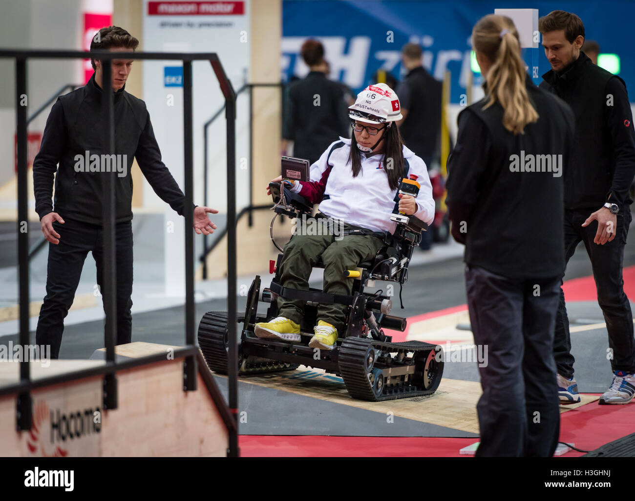 Kloten, Switzerland. 8th Oct, 2016. Cho Yu NG (CHN) passes a wheelchair obstacle course at Cybathlon, the first championship for racing pilots with disabilities using bionic devices at the Swiss Arena in Kloten (Zurich), Switzerland. Organized by the Swiss Federal Institute of Technology (ETH) in Zurich, Cybathlon brings together interdisciplinary teams of bio-engineers, scientists and athletes with physical disabilities to compete in solving everyday tasks and to demonstrate how technology enables them to overcome physical limitations of their body. Credit:  Erik Tham/Alamy Live News Stock Photo