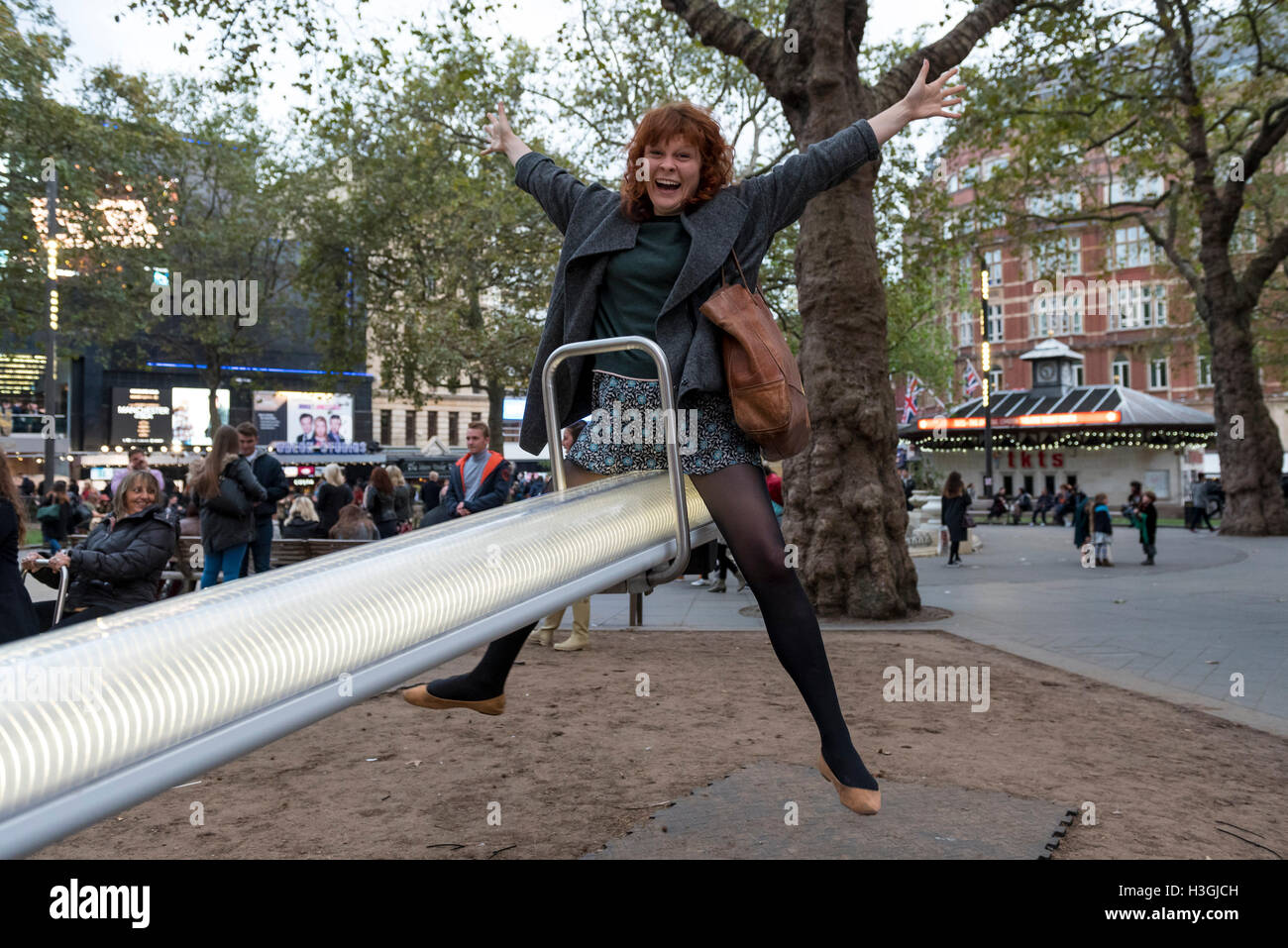 London Uk Members Of The Public Enjoy Riding On The Illuminated See Saws In Leicester Square 