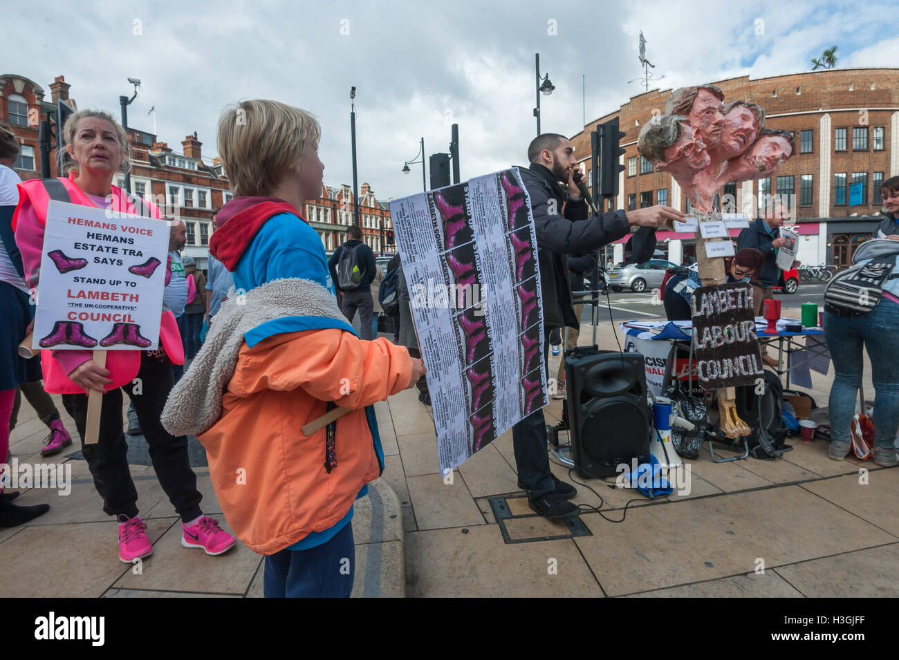 London, UK. 8th October 2016. Rapper Potent Whisper performs at 'Stand Up to Lambeth' in WIndrush Square, Brixton, the launch of a series of events against the policies of the council, calling on it to stop demolishing council estates, closing libraries and driving out local businesses with the closure of the Brixton Arches. Protesters accuse the Labour council of financial waste and 'destroying our communities, racial and social inequality' and 'stealing the people of Lambeth's future. Credit:  Peter Marshall/Alamy Live News Stock Photo