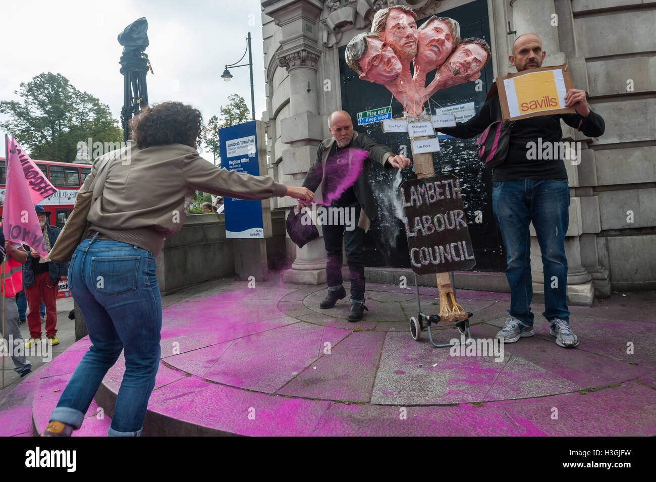 London, UK. 8th October 2016. Campaigners in Lambeth, the most unequal borough in the whole of England and Wales, pause to throw glitter on the steps of Lambeth Town Hall on their march from Brixton to march to a picnic on Clapham Common launching a series of events against the policies of the council, calling on it to stop demolishing council estates, closing libraries and driving out local businesses with the closure of the Brixton Arches. Credit:  Peter Marshall/Alamy Live News Stock Photo