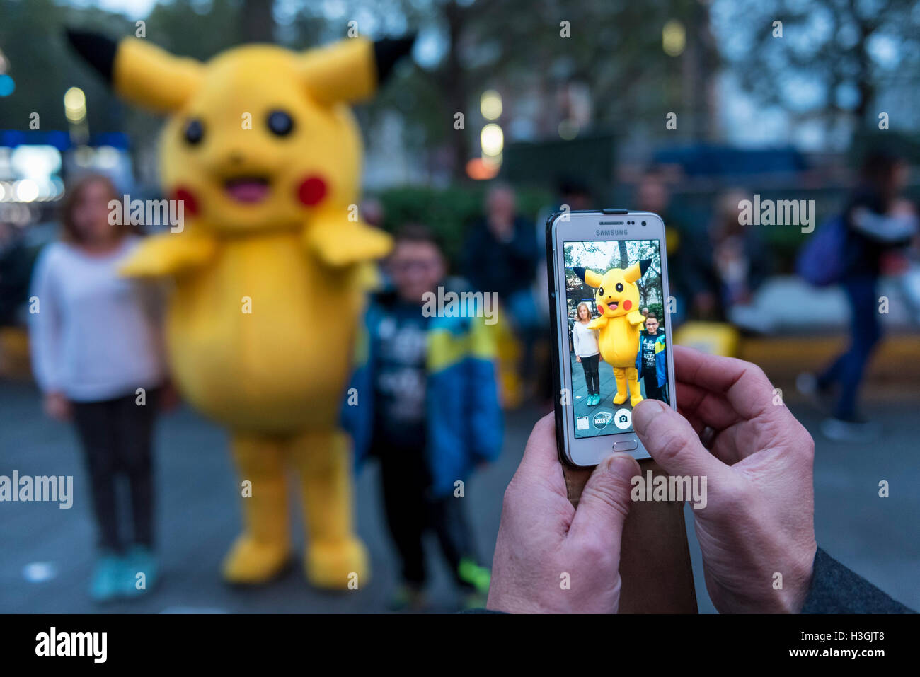 London Uk With People Still Gripped By The Worldwide Pokemon Go Craze Tourists Pose With A Street Performer Dressed As A Life Size Pikachu Character In Leicester Square Credit Stephen Chung Alamy