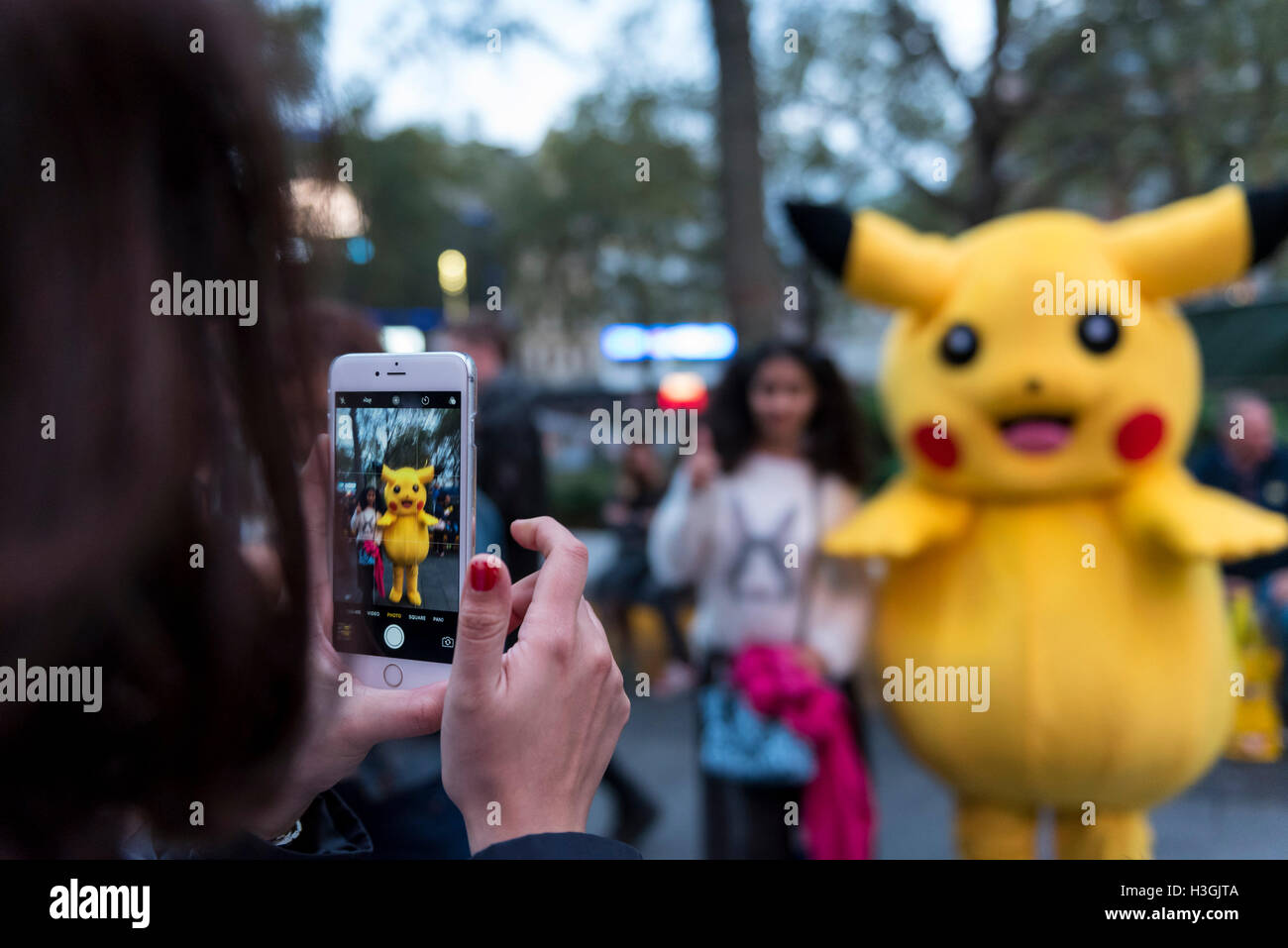 London Uk With People Still Gripped By The Worldwide Pokemon Go Craze Tourists Pose With A Street Performer Dressed As A Life Size Pikachu Character In Leicester Square Credit Stephen Chung Alamy