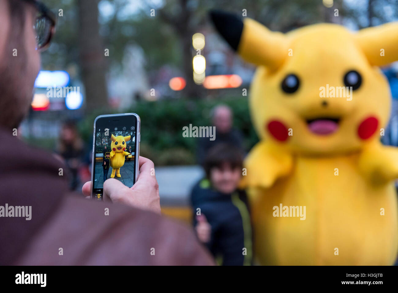 London Uk With People Still Gripped By The Worldwide Pokemon Go Craze Tourists Pose With A Street Performer Dressed As A Life Size Pikachu Character In Leicester Square Credit Stephen Chung Alamy