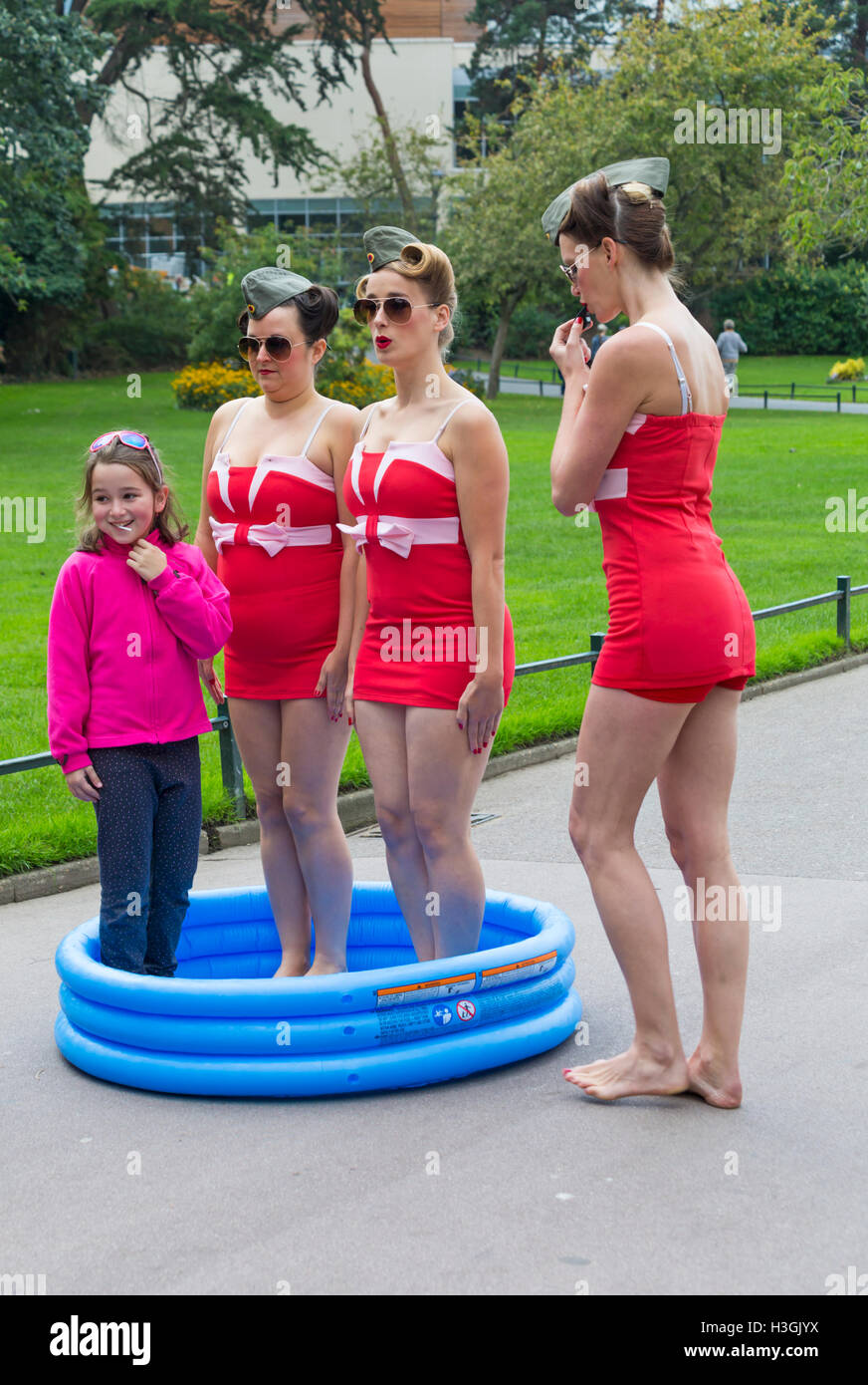 Bournemouth, Dorset, UK. 8 October 2016. Bournemouth Arts by the Sea Festival returns for a sixth year with festival entertainment. Kitsch n Sync introduce a splash of nostalgia and seafaring mischief to Bournemouth as the three costume clad damsels Pseudo Synchro Swim Team are out and busy in training; being drilled by their swim captain with military precision. Credit:  Carolyn Jenkins/Alamy Live News Stock Photo