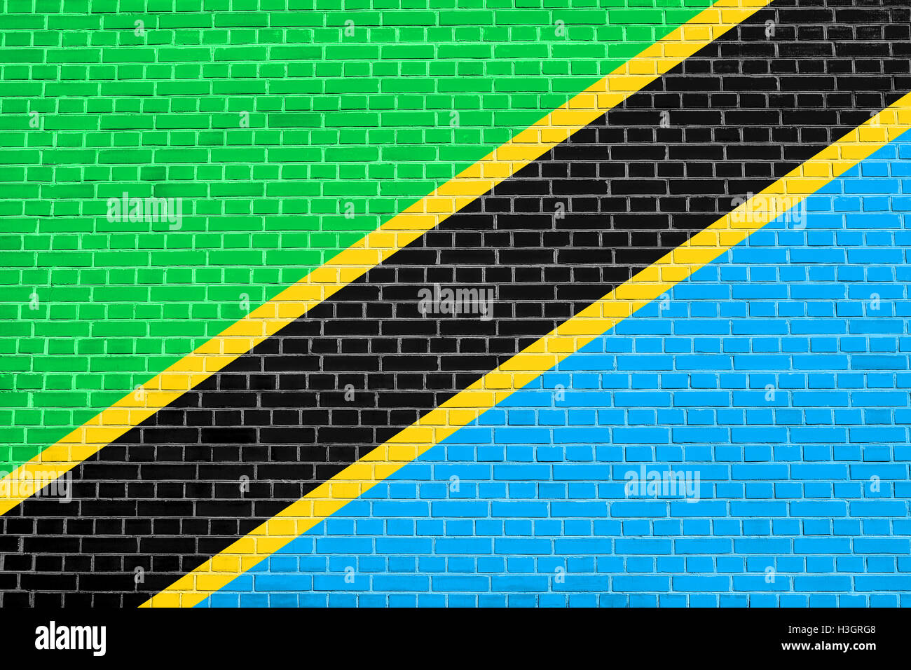 Tanzanian national official flag. African patriotic symbol, banner, element, background. Flag of Tanzania on brick wall texture Stock Photo