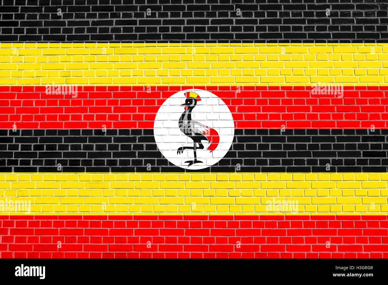 Ugandan national official flag. African patriotic symbol, banner, element, background. Flag of Uganda on brick wall texture back Stock Photo