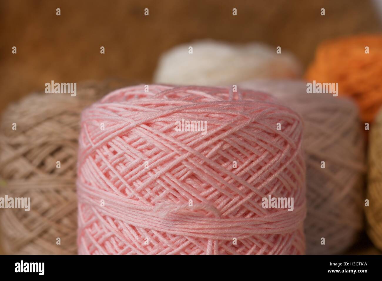 Balls of wool cotton silk Brown Pink White and Orange close-up Stock Photo